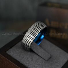 a blue ring sitting on top of a wooden box