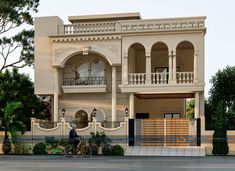 a large white building with two bicycles parked in front of it