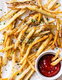 french fries with ketchup and parmesan cheese on the side, ready to be eaten