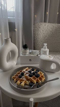 a plate with waffles and blueberries on it