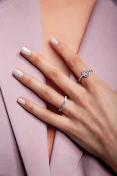 a woman's hand with two rings on her left and one ring on her right