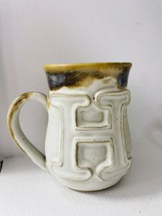 a white and brown mug sitting on top of a table