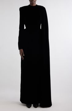 Demna offers a dramatic take on special-occasion dressing with this runway-featured velvet gown that showcases padding at the hips and a floor-skimming cape-inspired detail. 59" length (size 38FR) Hidden back-zip closure Crewneck Long sleeves Partially lined 65% viscose, 35% cupro Dry clean Made in Italy Designer Clothing Luxury Fitted Gown For Red Carpet, Luxury Fitted Velvet Evening Dress, Luxury Fitted Evening Dress For Red Carpet, Fitted Velvet Gown For Evening, Luxury Velvet Gown, Velvet Evening Dress With Sweep Train, Fitted Velvet Floor-length Dress For Gala, Fitted Floor-length Velvet Dress For Gala, Velvet Evening Gown Floor-length