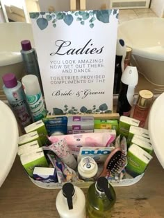 a basket filled with personal care products on top of a wooden table next to two sinks