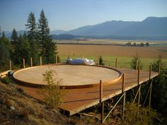 a large wooden deck in the middle of a field