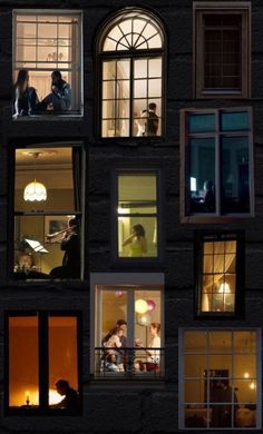 many windows with people sitting in them at night