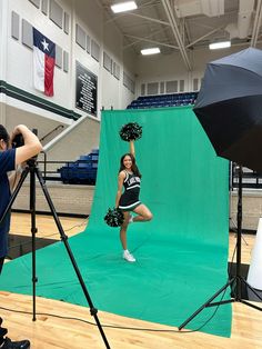 a cheerleader standing in front of a green screen