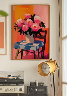 a painting on the wall above a record player and table with flowers in vases