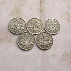 six ancient roman coins on a marble surface