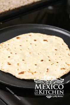 a tortilla sitting on top of a black plate