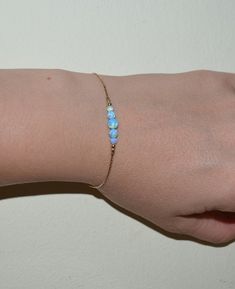 Delicate 14k Gold Filled bracelet with blue opal beads bar. This is simple and classic piece of jewelry for everyday wear. M a t e r i a l s Your bracelet can be made of the following materials: Sterling Silver or 14k Gold Filled. Please select material during checkout process. M e a s u r e m e n t s - Available bracelet lengths: 6, 6.5, 7, 7.5, 8 inches - The length of the entire bracelet is measured from end to end - Model on the pics wears 7 inches bracelet P a c k a g i n g Your order will Animal Cuddles, Teal Bracelet, Blue Opal Jewelry, Raw Opal Ring, Gold Bracelet Simple, Bff Jewelry, Jewelry Opal, Arm Bracelets, Bracelet Simple