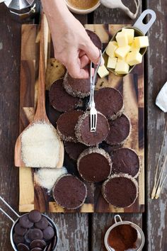 chocolate cupcakes on a cutting board with butter and sugar