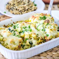 a casserole dish with broccoli, cheese and other food in it