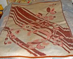 a bed with a red and white blanket on top of it