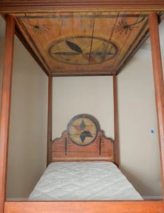 a bed frame with a clock painted on it