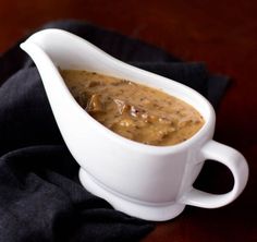 a white gravy dish on a black cloth