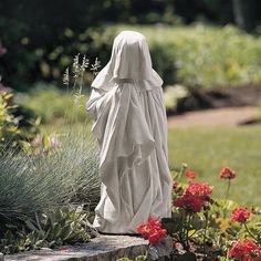 a statue of a woman in a garden