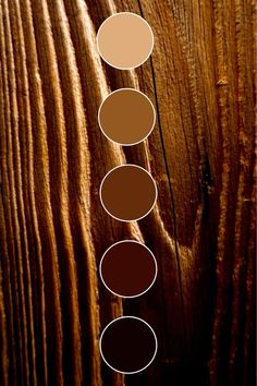 a wooden surface with five different shades of brown and tan on the top, one is darker than the other