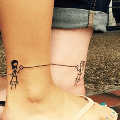 two people with small tattoos on their feet