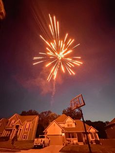 fireworks in the night sky above houses