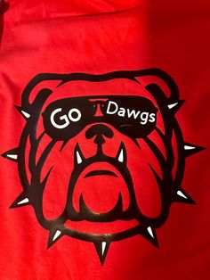 Georgia Football Bulldog Game Day Shirt, Cute Shirts for Women, Tailgate Gameday Shirt, College Football Shirt, Perfect Gift for Him/Her CARE INSTRUCTIONS: *Designs are applied with high quality heat transfers. For longest results, shirts should be washed inside out, without fabric softener and dried on low heat. PROCESSING & SHIPPING: *All of our items are hand crafted & made to order, so please allow up to 3 to 5 business days for your order to ship. Shirts are shipped via USPS First Class Mail unless Priority upgrade is chosen at checkout. Once the items is handed to USPS, we are not responsible for lost/stolen/damaged packages. SHOP POLICIES: *Please read our shop policies for CANCELLATIONS/REFUNDS/EXCHANGES Uga Shirts Vinyl, Georgia Bulldog Shirts, Sparkle Georgia Bulldog Shirt, Georgia Bulldog Glitter Shirt, Red Georgia Bulldog Shirt, Georgia Bulldogs Shirt, Tailgate Shirt, Georgia Football, Bulldog Shirt