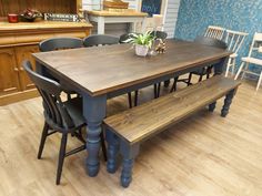 a wooden table and bench in a room