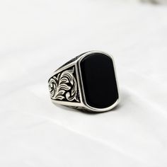 Make a statement of strength and style with this striking black onyx men's ring. Perfect for everyday wear or special occasions, the deep black hue of the onyx stone is set off beautifully by the silver or gold metal band. This elegant and timeless piece is sure to become a staple in any man's accessory collection. Handcrafted with care and attention to detail, this black onyx men's ring is a sophisticated choice for the modern gentleman. Material : 925 Sterling Silver Gemstone    : Onyx Stone C Black Onyx Engagement Ring Men, Black Onyx Ring Men, Onyx Ring Men, Black Onyx Engagement Ring, Ring Men, Black Onyx Ring, Modern Gentleman, Personalized Rings, Metal Band