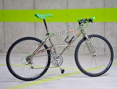 a bike is parked in an empty parking lot with green and white stripes on the wall