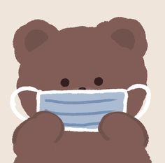 a brown teddy bear wearing a face mask