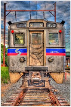 an old train car sitting on the tracks