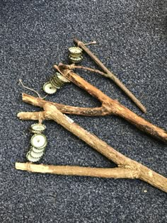 three pieces of driftwood are arranged in the shape of a christmas tree with ornaments on them