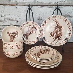 a table topped with plates and bowls on top of a wooden table