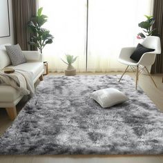 a living room filled with furniture and a large rug