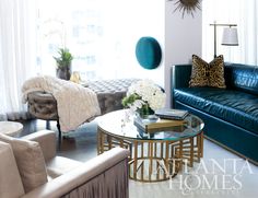 a living room with couches, chairs and a table in front of a window