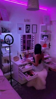 a woman standing in front of a desk with an open drawer