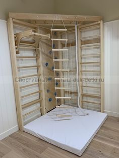 an unfinished room with ladders and mattresses on the floor in front of it