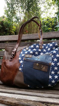 a handbag with an american flag design on it sitting on top of a wooden bench