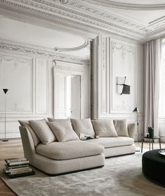 a living room filled with furniture and white walls