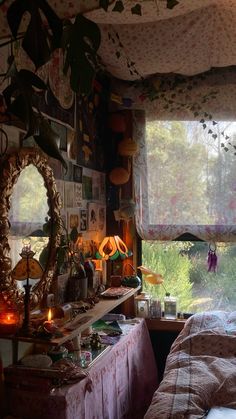 a bedroom with a bed, mirror and plants on the window sill in front of it