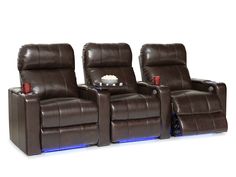 three reclining chairs with remotes in front of them