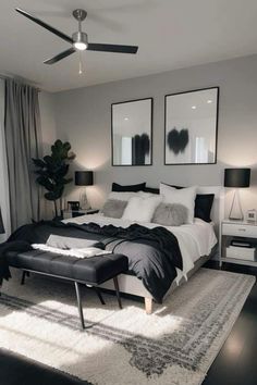 a large bed sitting in a bedroom next to two lamps and pictures on the wall