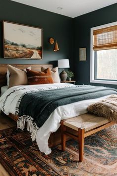 a bedroom with a bed, rugs and pictures on the wall