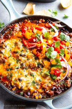 a skillet filled with mexican food and garnished with cilantro