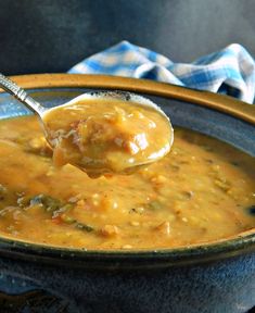 a spoon full of soup is being held up