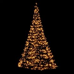 a lighted christmas tree in the dark with lights on it's sides and bottom