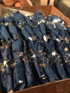 a box full of blue napkins with gold stars on them