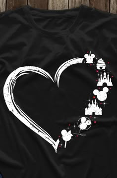 a black shirt with mickey mouse's castle in the shape of a heart on it