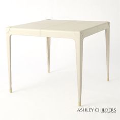 a small white table with two legs and a square shaped design on the top, against a white background