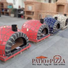 three pizza ovens with different designs on them