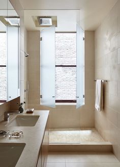 a bathroom with two sinks and mirrors in it